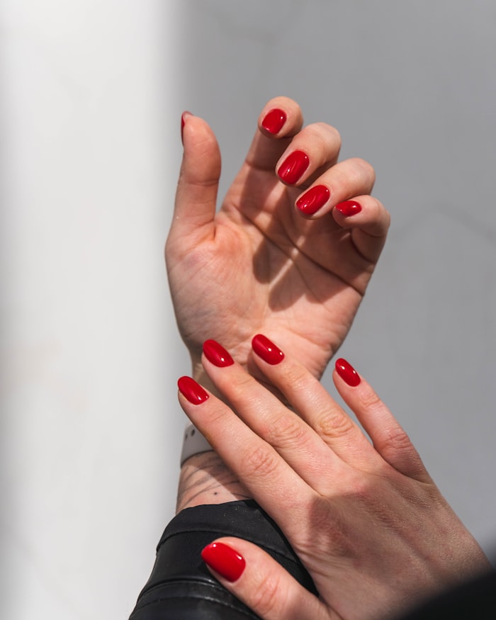 Classic cherry-red manicure on both hands
