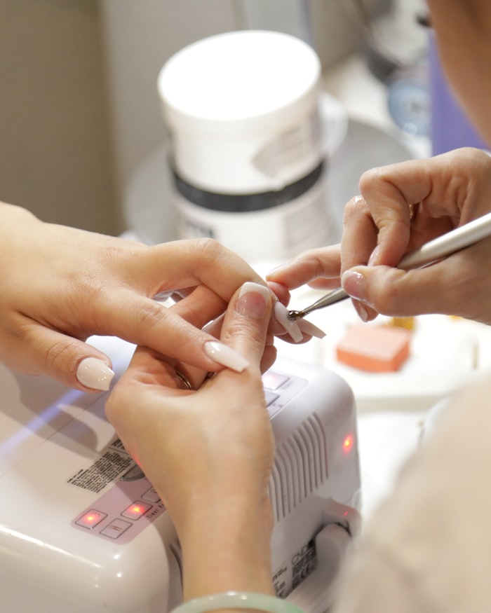 Nude manicure being finished at the studio desk